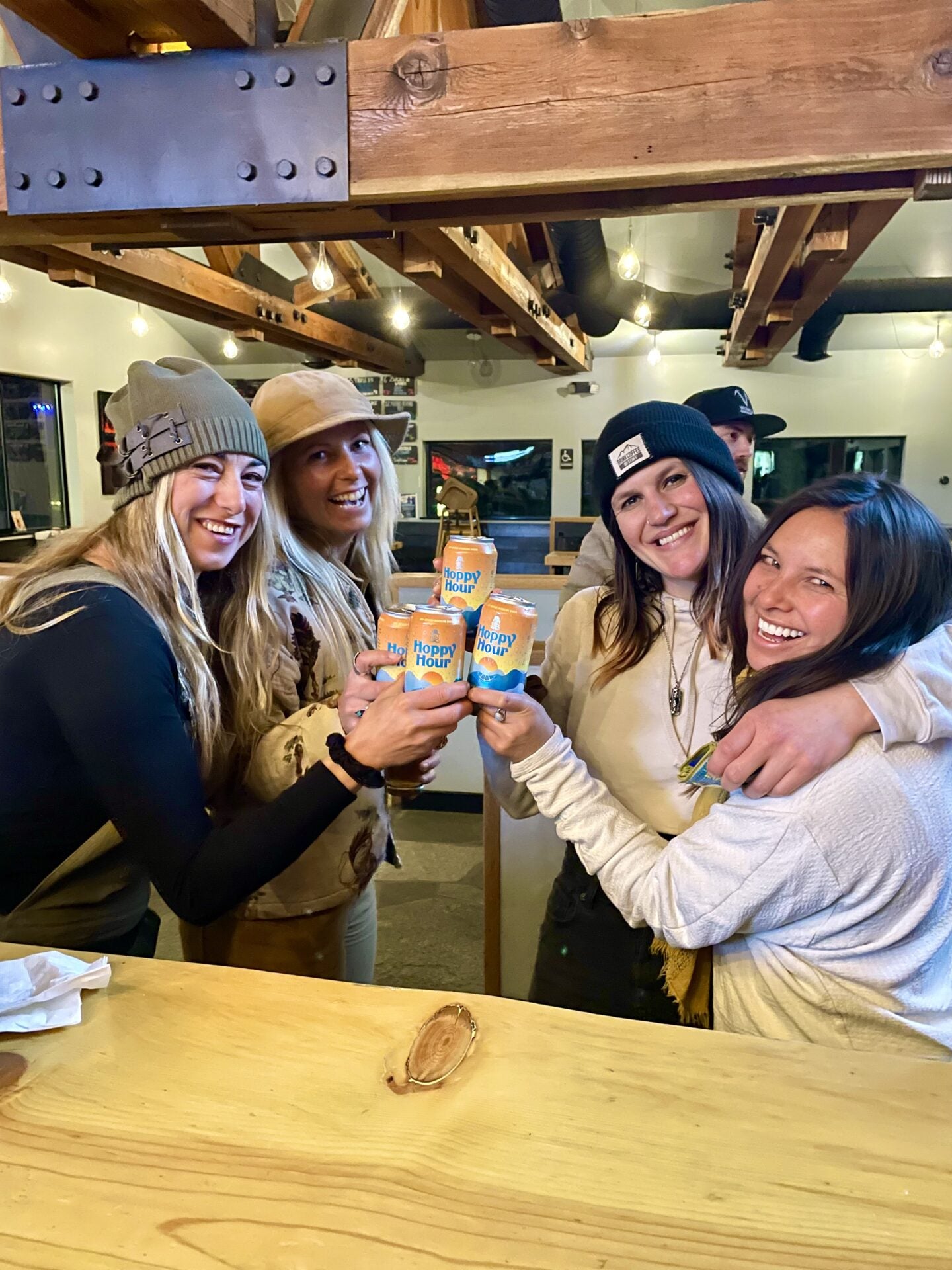 Friends cheers with Hoppy Hour at a bar