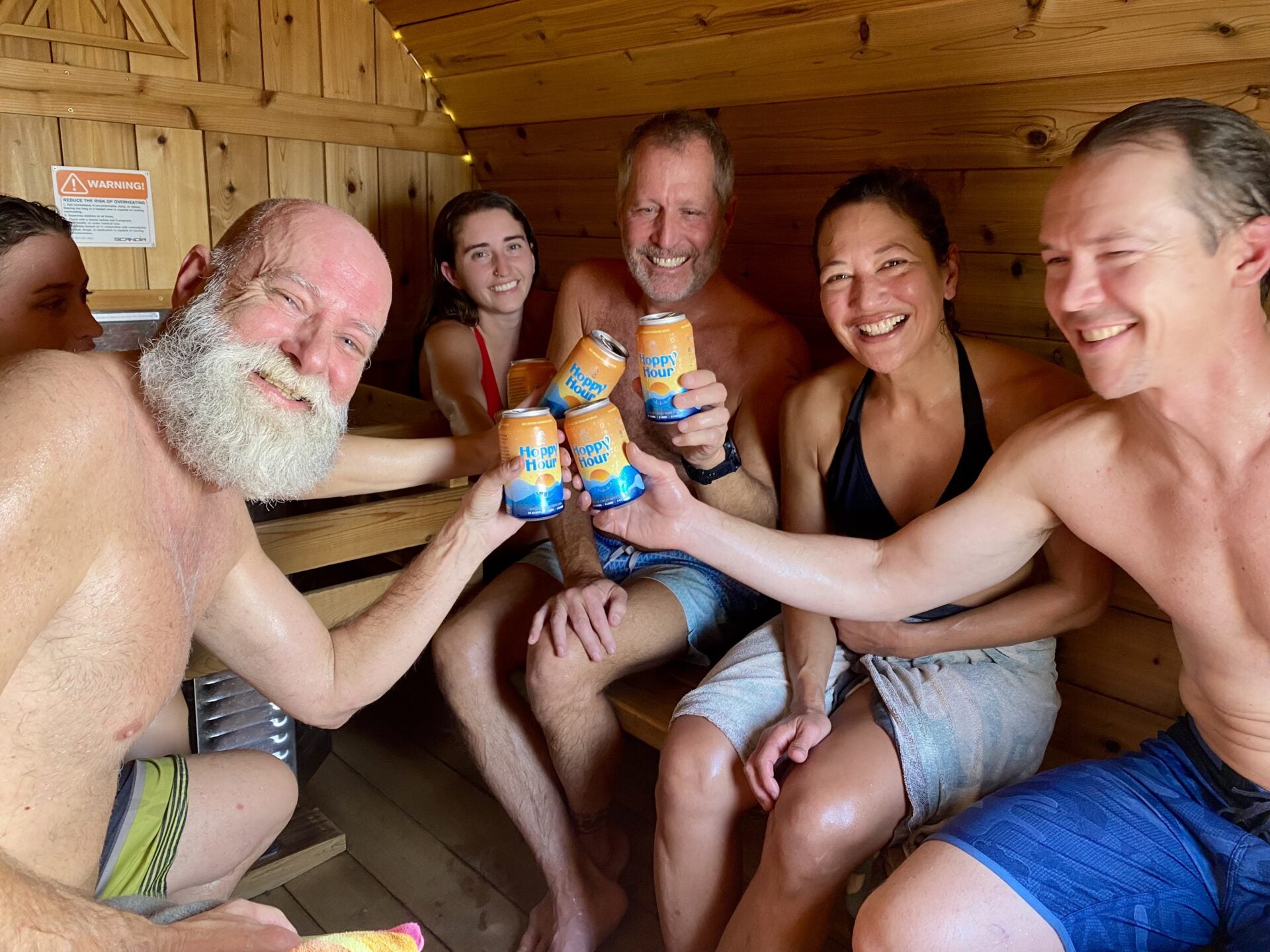 Friends drinking Hoppy Hour in a sauna